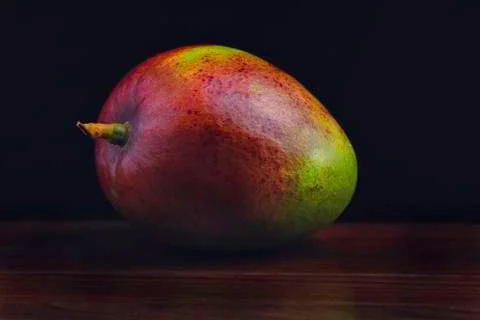 Mango on the wooden table, dark background Stock-Fotos