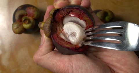 Mangosteen pulp being stirred with a fork Video stock 302393111