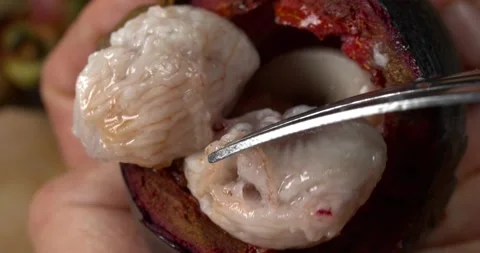 Mangosteen pulp being stirred with a fork close up Video stock 302393124