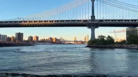 Manhattan Bridge East River View With Cargo Barge And DUMBO Pebble Beach NYC 스톡 동영상 343037360