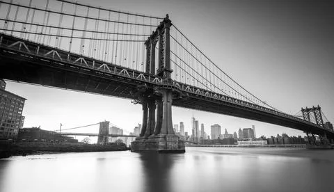 Manhattan Bridge seen from the coast next to the D.U.M.B.O area, during dus.. Stock Photos