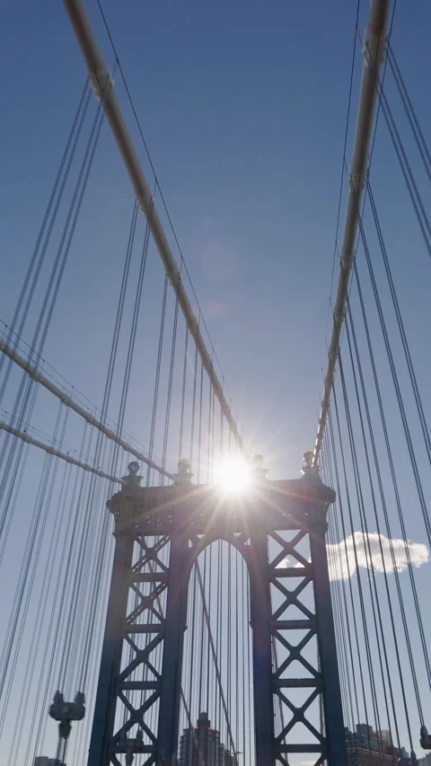 Manhattan Bridge tower with bright sun and suspension cables in New York City Stock Footage 333296827