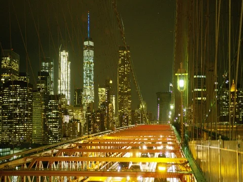 Manhattan skyline and traffic on the Brooklyn Bridge at night. Stock Footage 73335256