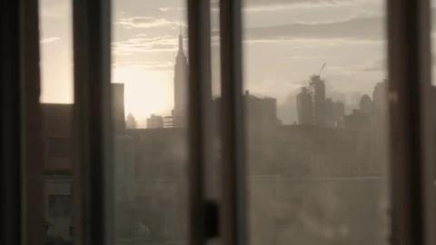 Manhattan skyline seen through a window. Sunset. Camera panning. Long lens. Vídeo Stock 75271728
