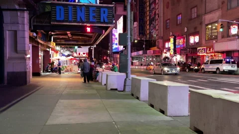 Manhattan traffic passes large illuminated Diner sign entrance at night Stock Footage 196895366