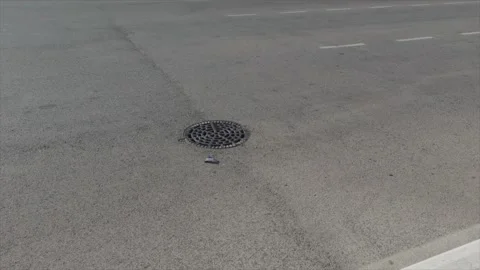Manhole cover on asphalt road surface in Morocco Stock Footage 334504784