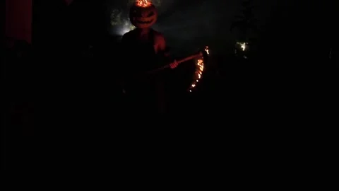 A maniac with a burning pumpkin instead of a head and Stock Footage 251829699
