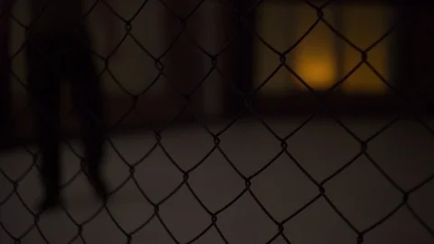 Maniac in a cage with a machete Stock Footage 122137891