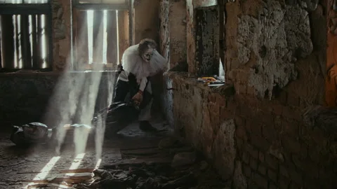 Maniac in Clown Costume Dragging Corpse in Black Garbage Bag across Floor Stock Footage 250951021