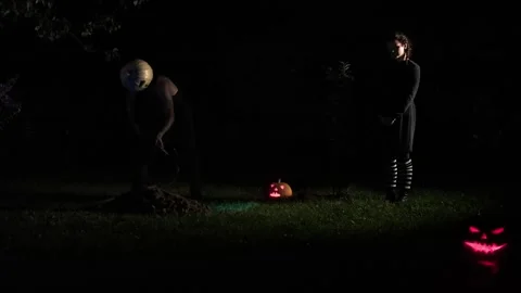 A maniac digs a grave, a monster digs a hole and notices Stock Footage 251821201