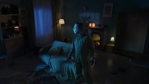 Maniac with knife walking through room, girl comes out from the next door Stock Footage 250449760