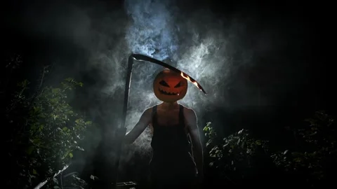Maniac with a pumpkin instead of a head and a burning scythe, scary monster Stock Footage 251820688