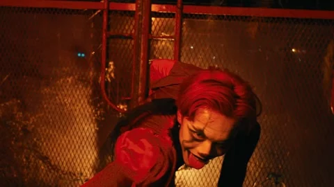 Maniacal Red-Haired Clown Crawling and Contorting Indoors Stock Footage 264284747