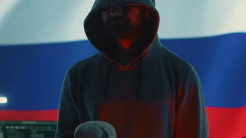 A maniacal russian hacker creating cyber threat alert by holding a skull Stock Footage 277658105