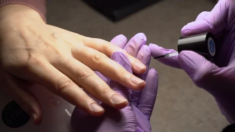 Manicure applying, brushing fingernails with clear enamel Stock Footage 102536963