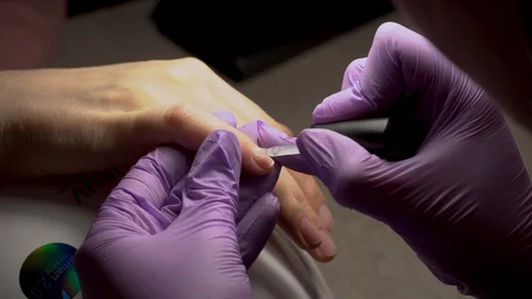 Manicure applying, brushing fingernails with clear enamel Stock Footage 102537019