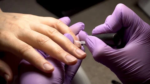 Manicure applying, brushing fingernails with clear enamel Stock Footage 102537042