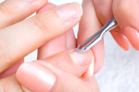 Manicure applying - cleaning the cuticles Stock Photos