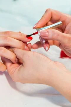 Manicure. applying red nail polish 写真素材