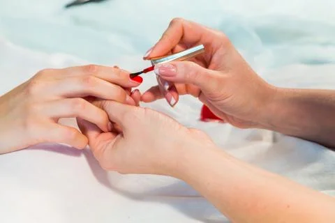 Manicure. applying red nail polish Stock Photos