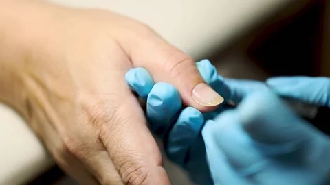 Manicure applying shellac or nail polish to elder female person. caucasian 50 Stock Footage 149439759