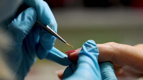 Manicure applying shellac or nail polish to elder female person. caucasian 50 Stock Footage 149439775