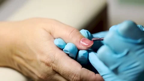 Manicure applying shellac or nail polish to elder female person. caucasian 50 Stock Footage 149439779