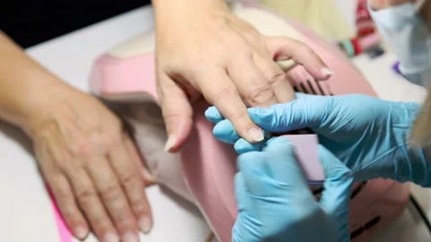 Manicure buffing and filing nails to elder female customer. caucasian 50 years Stock Footage 149439660