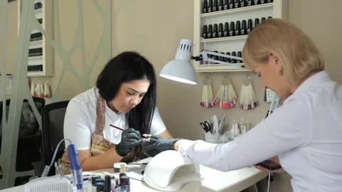 Manicure care procedure. Closeup view of beautician's hand filing nails of woman Stock Footage 145053953