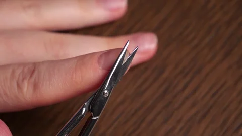 Manicure: cutting fingernails with small scissors in slow motion Stock Footage 311128890