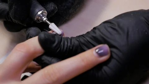 Manicure with the help of a nail polish machine. Stock Footage 119635421