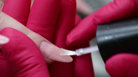 Manicure master applying nail polish. Stock Footage 130476232