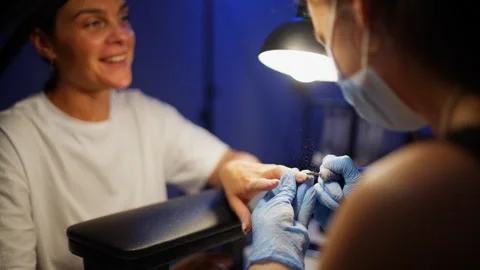 Manicure master cleaning female nails before nail polish application Stock-Footage 343528033