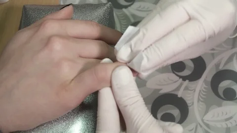 Manicure master clears the sticky layer from the gel polish Video stock 73446017