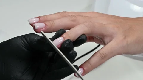 A manicure master does a Nails are filed with a file. Close-up Stock Footage 227474108