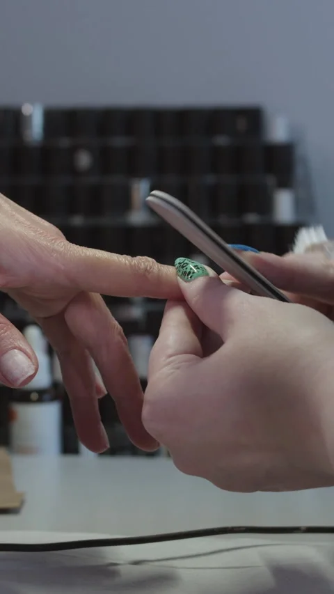 Manicure master files the clients nails with a nail file Stock Footage 328370926