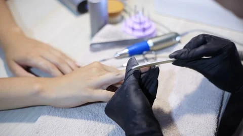 The manicure master gives shape to the nails with a nail file. Nail care Stock Footage 162224015