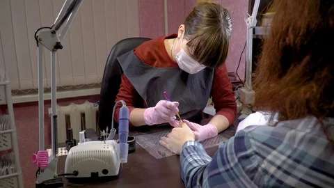 Manicure master makes the shape nail by applying gel Stock Footage 104057851