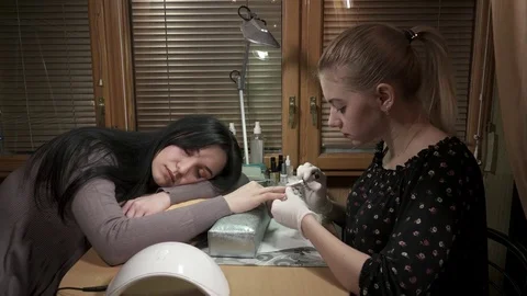 Manicure master making manicure while the customer is sleeping Stock Footage 73440433