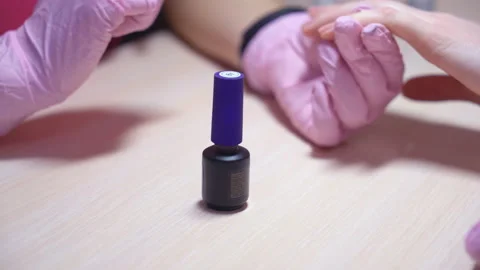 The manicure master paints the client nails with nail polish. beauty saloon Stock Footage 87044877