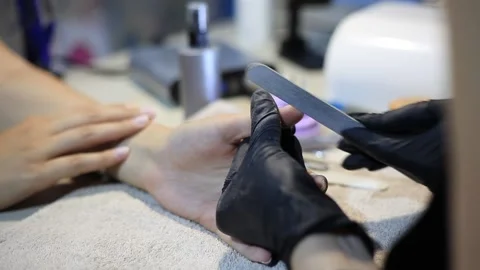A manicure master performs a nail care procedure before nail extensions. Stock Footage 162223534