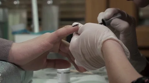 Manicure master polishing nails with the black polish Stock Footage 73440887