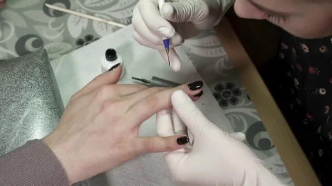 Manicure master polishing nails with the gel polish Stock Footage