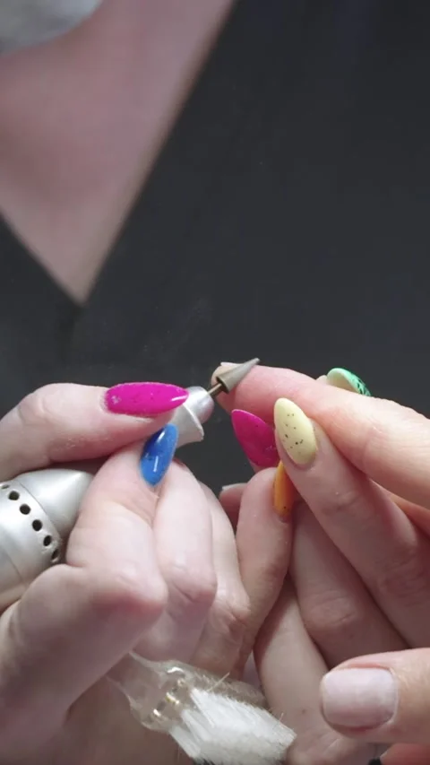 Manicure - the master processes the clients fingers using the device Stock Footage 328371208