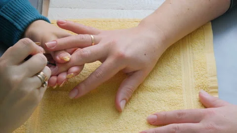 Manicure. The master puts on a transparent nail polish Stock Footage 86283928