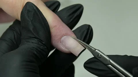 The manicure master in the salon cuts the cuticle. nails 4k Stock Footage 205524827