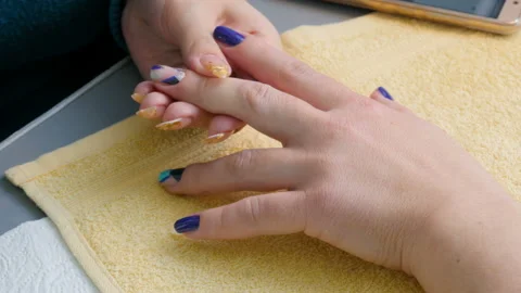 Manicure, nail lacquer, gel. The master makes a decorative manicure gel with a Stock Footage 86288369