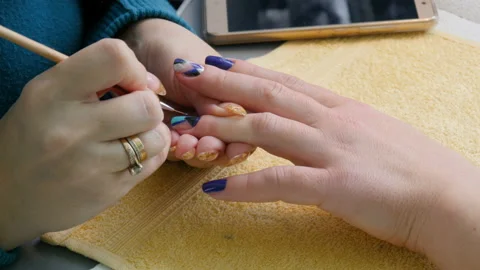 Manicure, nail lacquer, gel. The master makes a decorative manicure gel with a Stock Footage 86288979