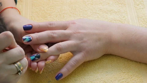 Manicure, nail lacquer, gel. The master makes a decorative manicure gel with a Stock Footage 86289415