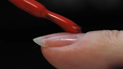 Manicure nail paint. Master applies gel polish on nails  in manicure salon. Stock Footage 124091005